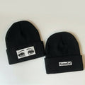 Two black beanies with eye design and 'KazooCat' logo on a white background
